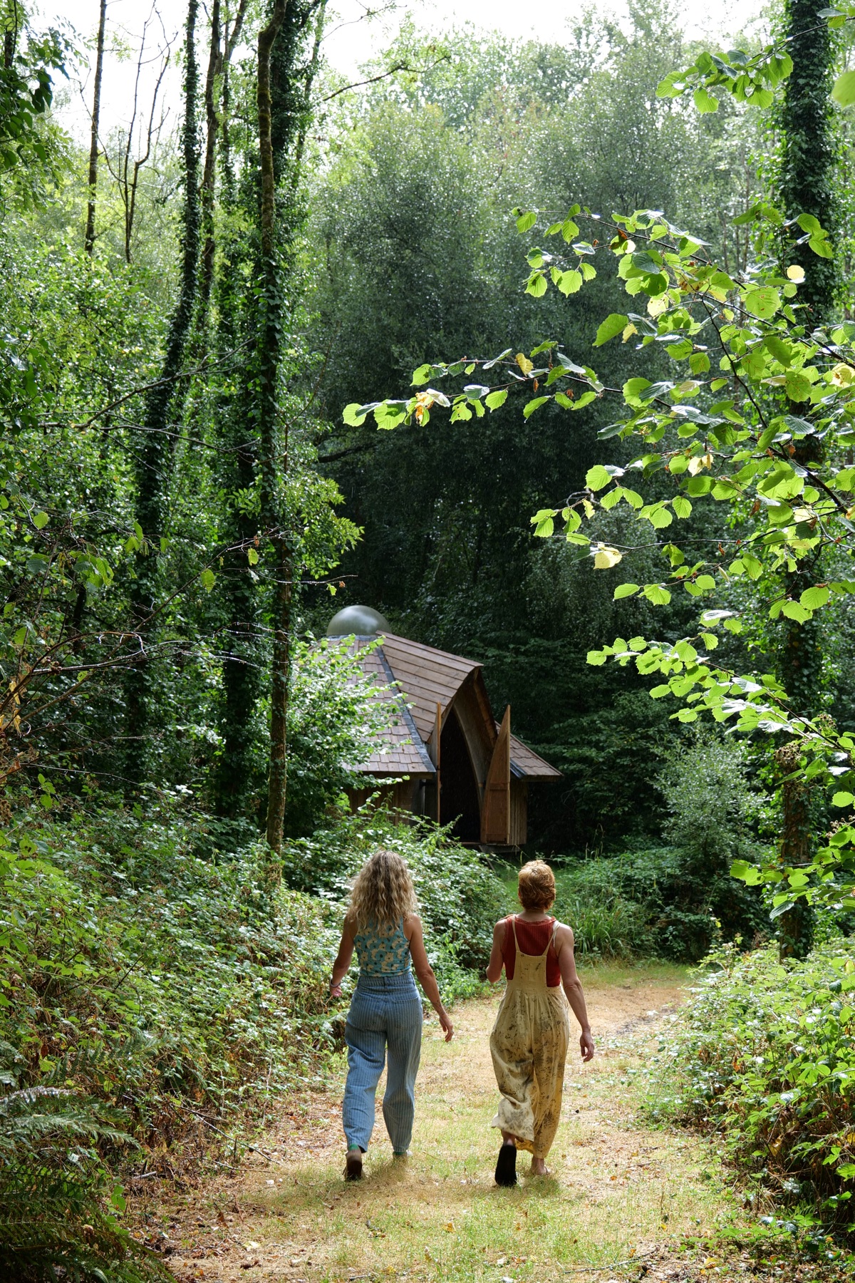Abbe and Hannah performing together in a woodland cabin